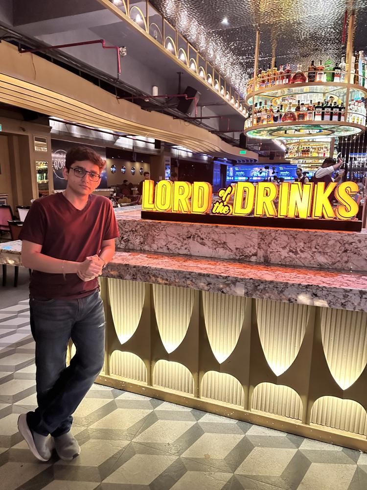 Standing at lord of the drinks bar