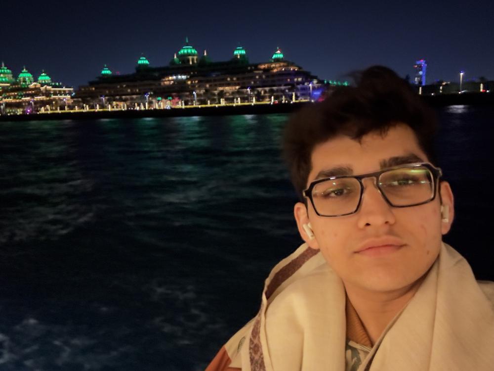 Night selfie by water lit ship