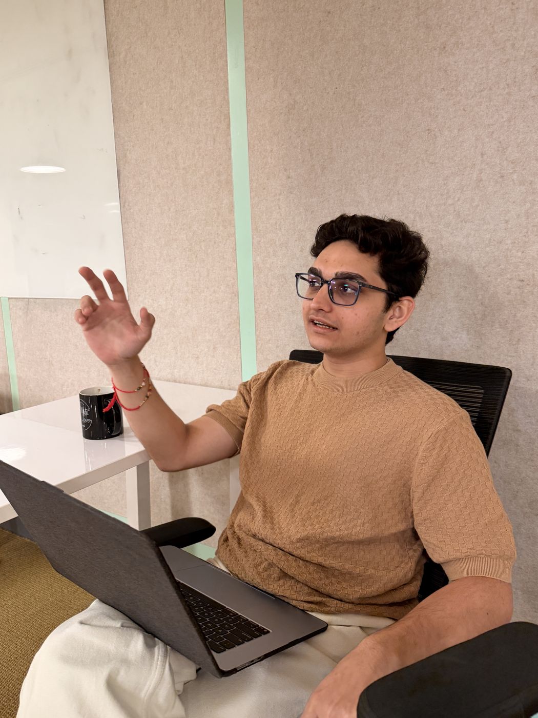 Kaneshk talking with a laptop